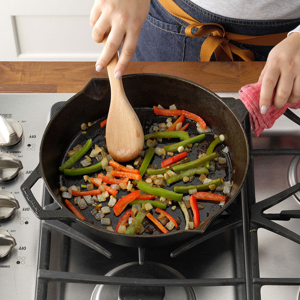 preparing vegetable stir fry in cast iron skillet