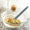 Taste of Home Spatula in Ash Gray, mixing batter in bowl with granola and bananas
