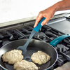 Taste of Home Nylon Slotted Turner with Ash Gray head, Sea Green handle, top view turning food in pan, lifestyle background