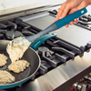 Taste of Home Nylon Spoon featuring Ash Gray head, Sea Green Handle, spooning batter into a pan, lifestyle background