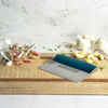 Taste of Home Bench Scraper with Sea Green handle, angled view on cutting board, lifestyle background