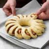pastry wreath on baking sheet
